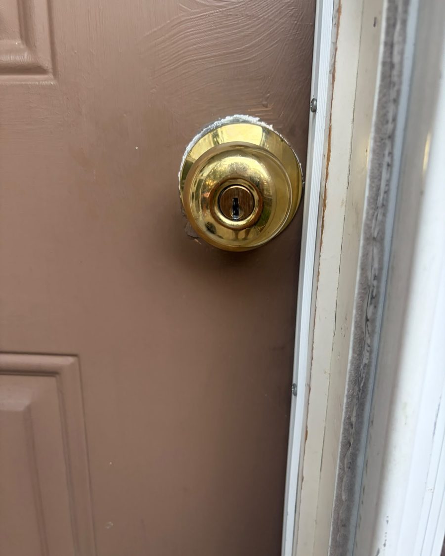 Brass deadbolt fitted to a timber door